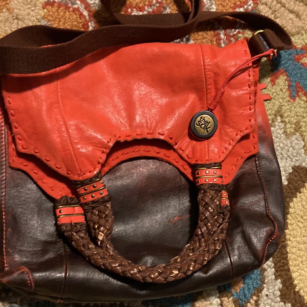 The Sak destress bright orange blends leather. cross body or handle purse